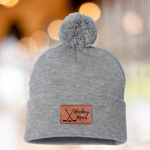 Load image into Gallery viewer, Hockey Mom Beanie Winter Hat Leather Patch Mom Gift Hockey Fan Winter Wear Warm Beanie Pom Top Cold Weather Rink Accessory Team Mom Sport