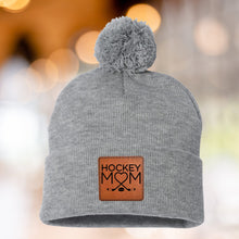 Load image into Gallery viewer, Hockey Mom Beanie Winter Hat Leather Patch Mom Gift Hockey Fan Winter Wear Warm Beanie Pom Top Cold Weather Rink Accessory Team Mom Sport