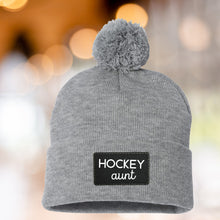 Load image into Gallery viewer, Hockey Aunt Beanie Winter Hat Leather Patch Aunt Gift Hockey Fan Winter Wear Warm Beanie Pom Top Cold Weather Rink Accessory Team Mom Sport