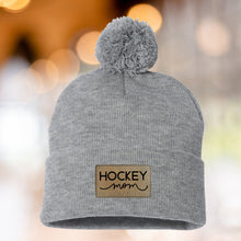 Load image into Gallery viewer, Hockey Mom Beanie Winter Hat Leather Patch Mom Gift Hockey Fan Winter Wear Warm Beanie Pom Top Cold Weather Rink Accessory Team Mom Sport