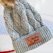 Load image into Gallery viewer, Hockey Mom Beanie Winter Hat Leather Patch Mom Gift Hockey Fan Winter Wear Warm Beanie Pom Top Cold Weather Rink Accessory Team Mom Sport