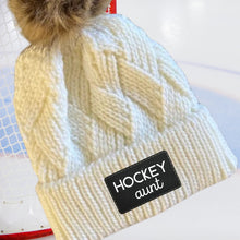 Load image into Gallery viewer, Hockey Aunt Beanie Winter Hat Leather Patch Aunt Gift Hockey Fan Winter Wear Warm Beanie Pom Top Cold Weather Rink Accessory Team Mom Sport